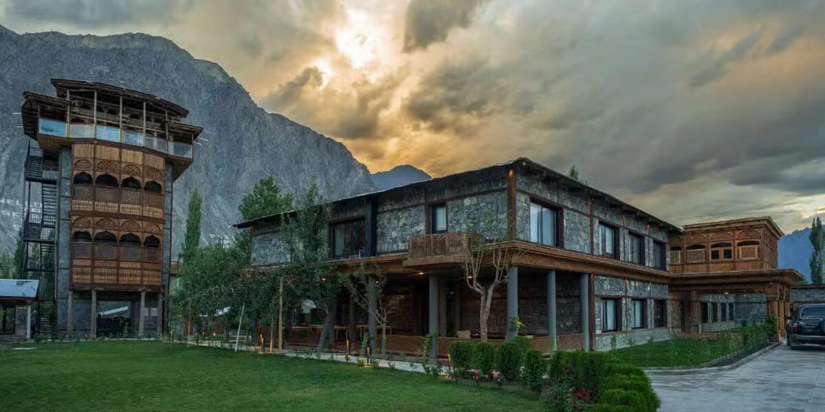 Stone and timber hotel at dusk below the Karakoram, Skardu