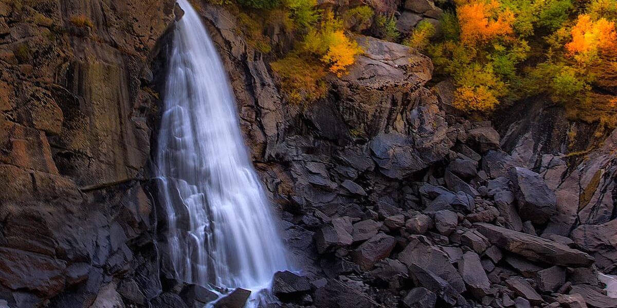 Waterfall falling into a rock pool in autumn, Baltistan near Skardu