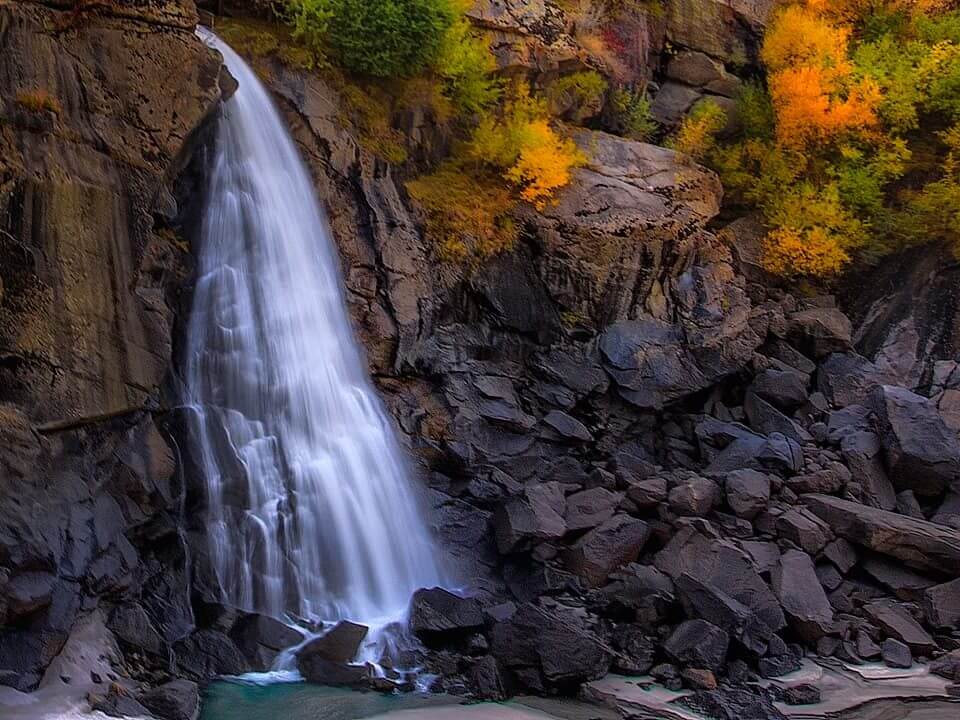 Waterfall falling into a rock pool in autumn, Baltistan near Skardu